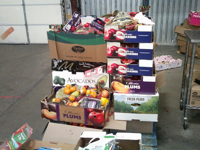 Produce boxes full of rotten produce on a pallet.
